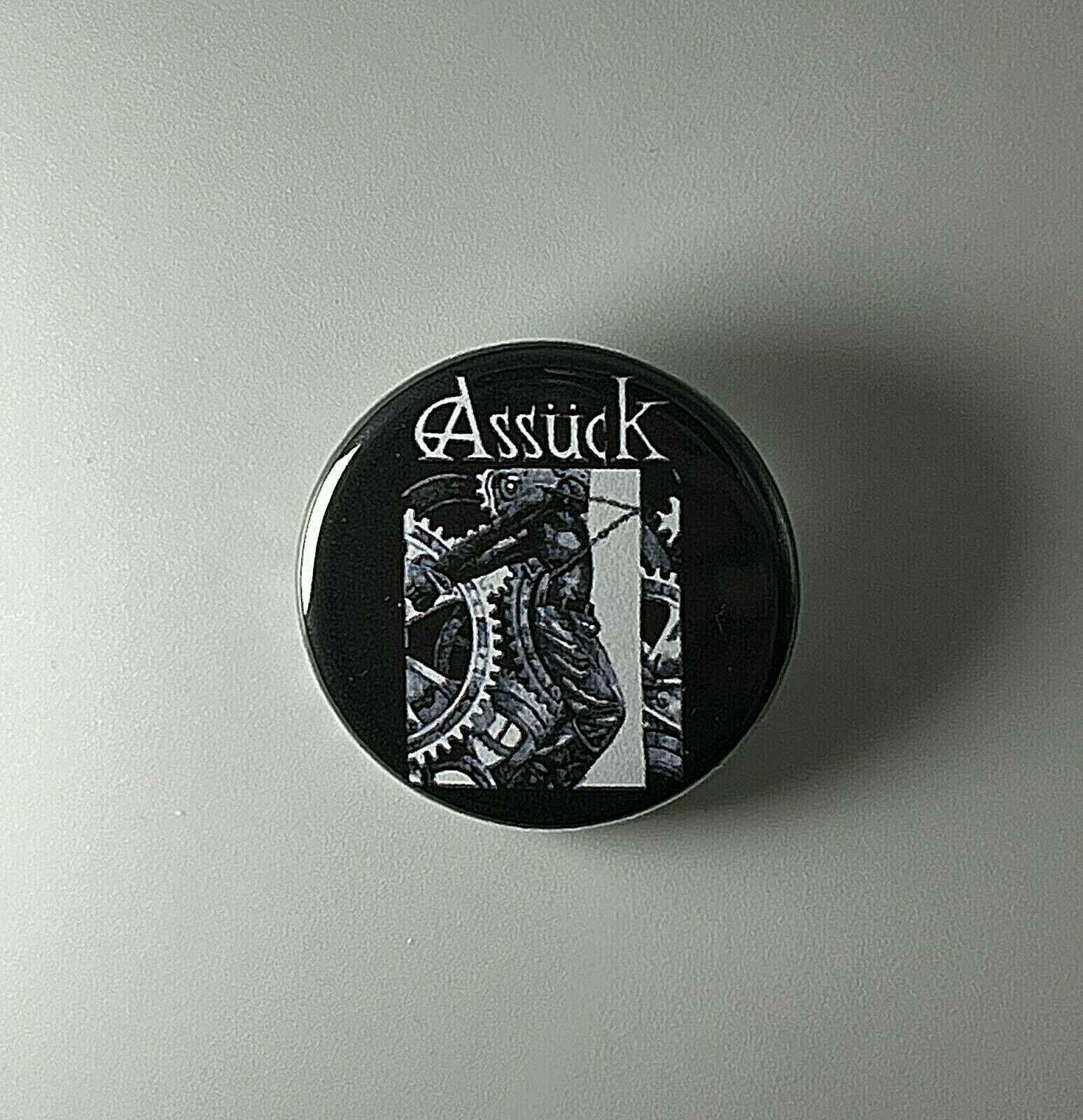 Assuck Anticapital 1.25″ Button A013B125