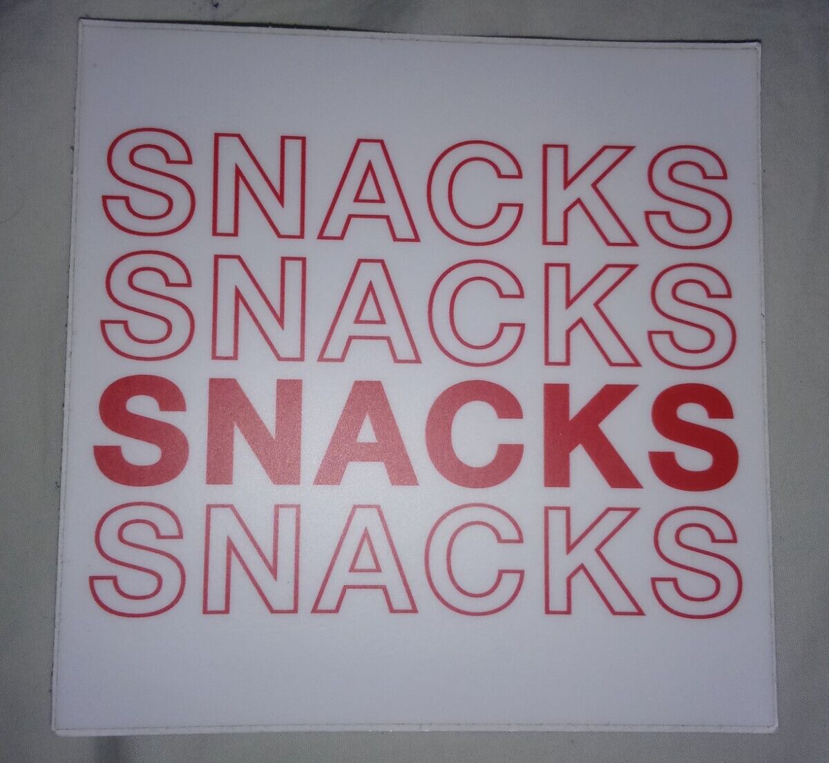 One Repeating Text Sticker: «Snacks» Design – 4.0″ X 4.0″