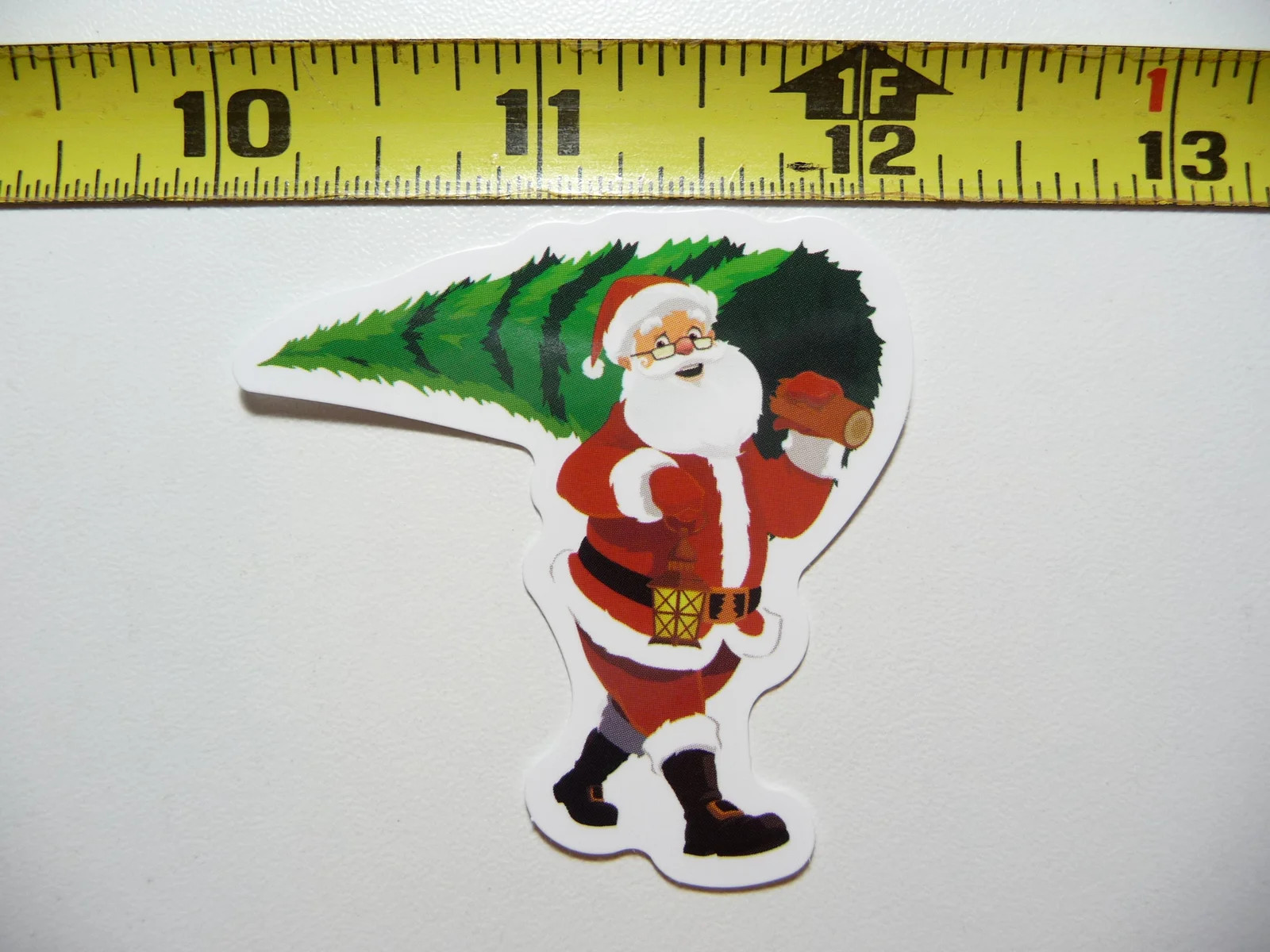 SANTA CLAUS CARRYING CHRISTMAS TREE SMALL STICKER DECAL WINTER CHRISTIAN